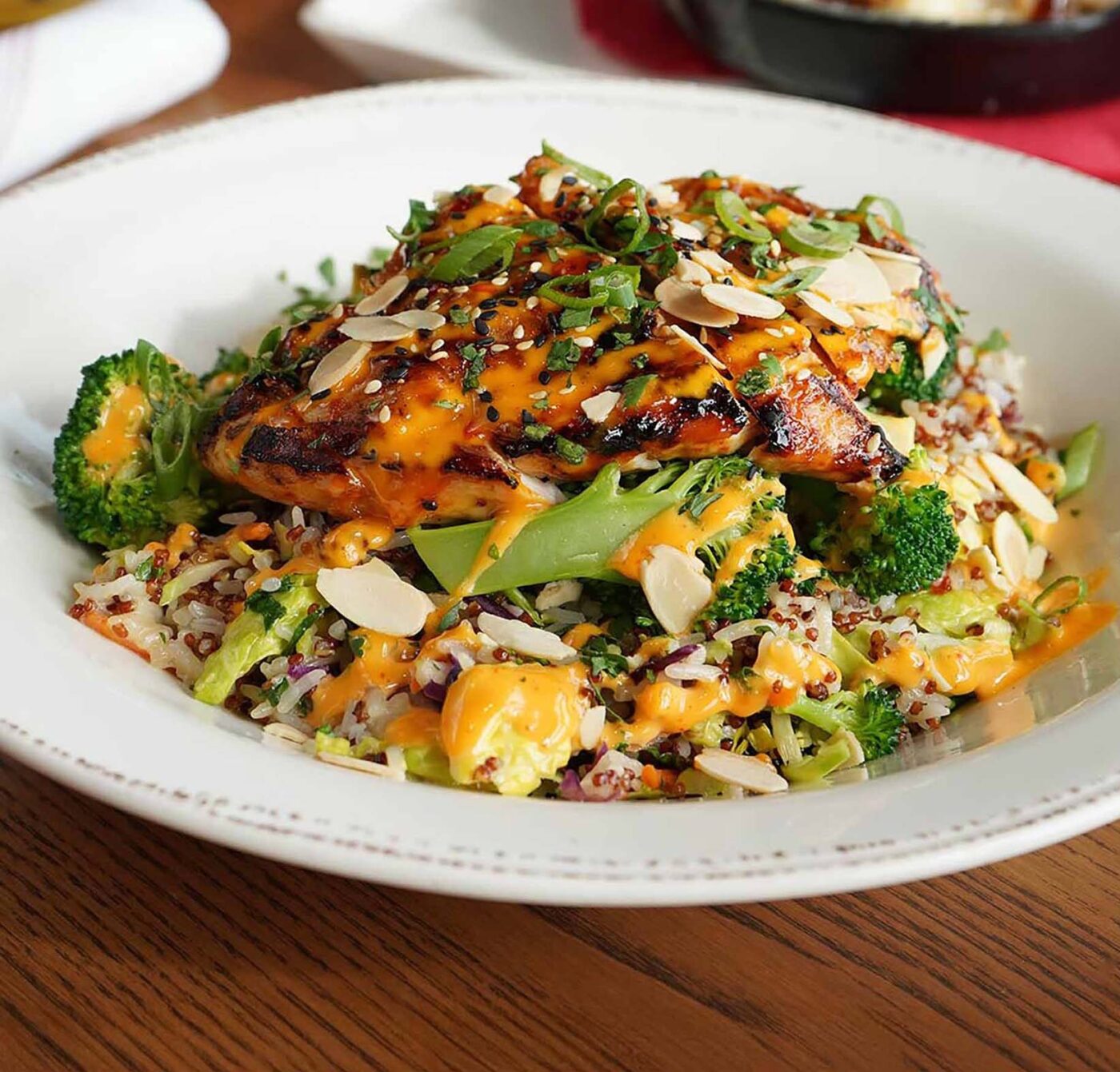 Sesame Ginger Bowl with grilled chicken, vegetables, and dressing in a white bowl