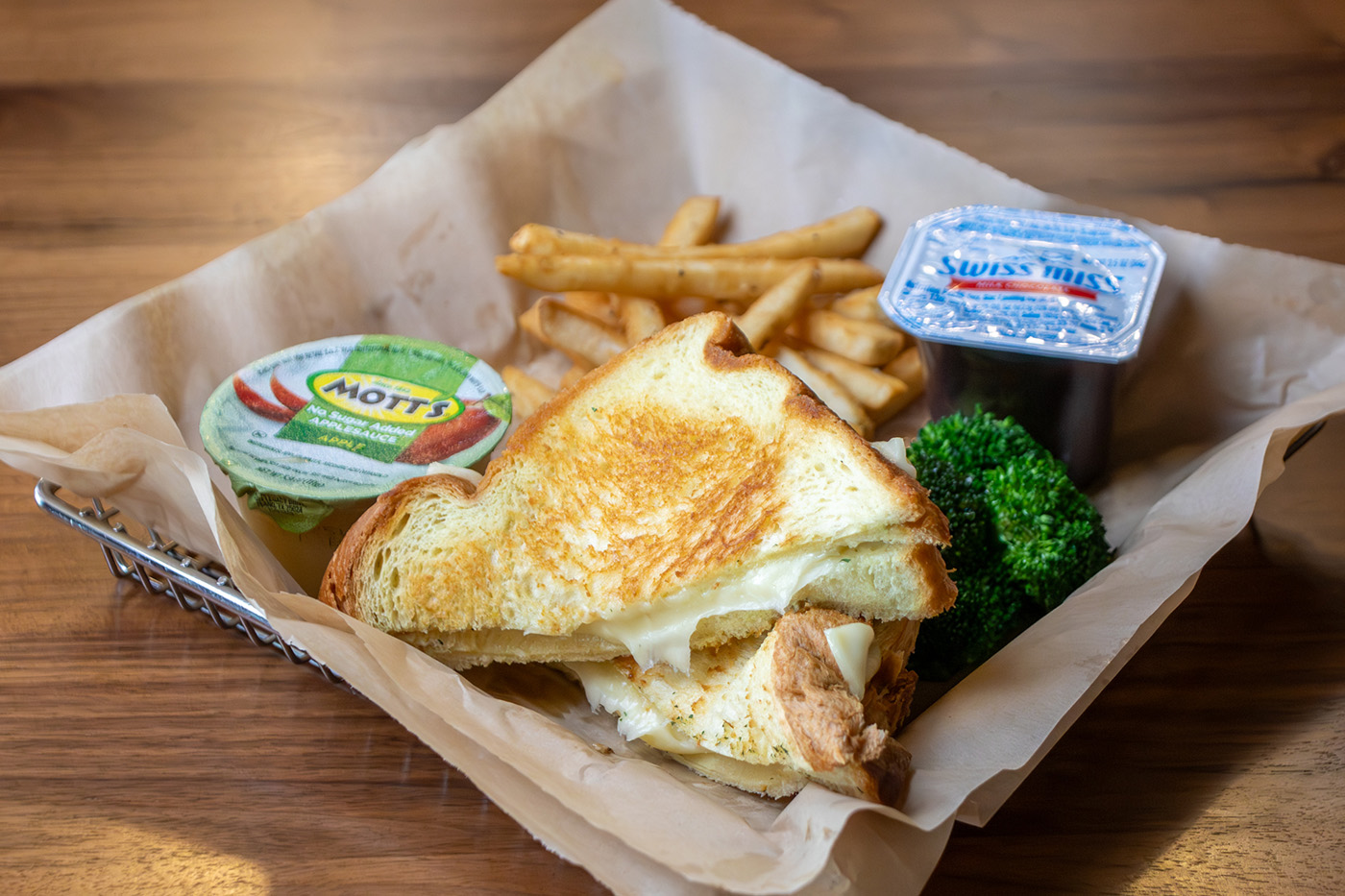 Kids Meal with a grilled cheese, side of broccoli, apple sauce, fries and a pudding cup
