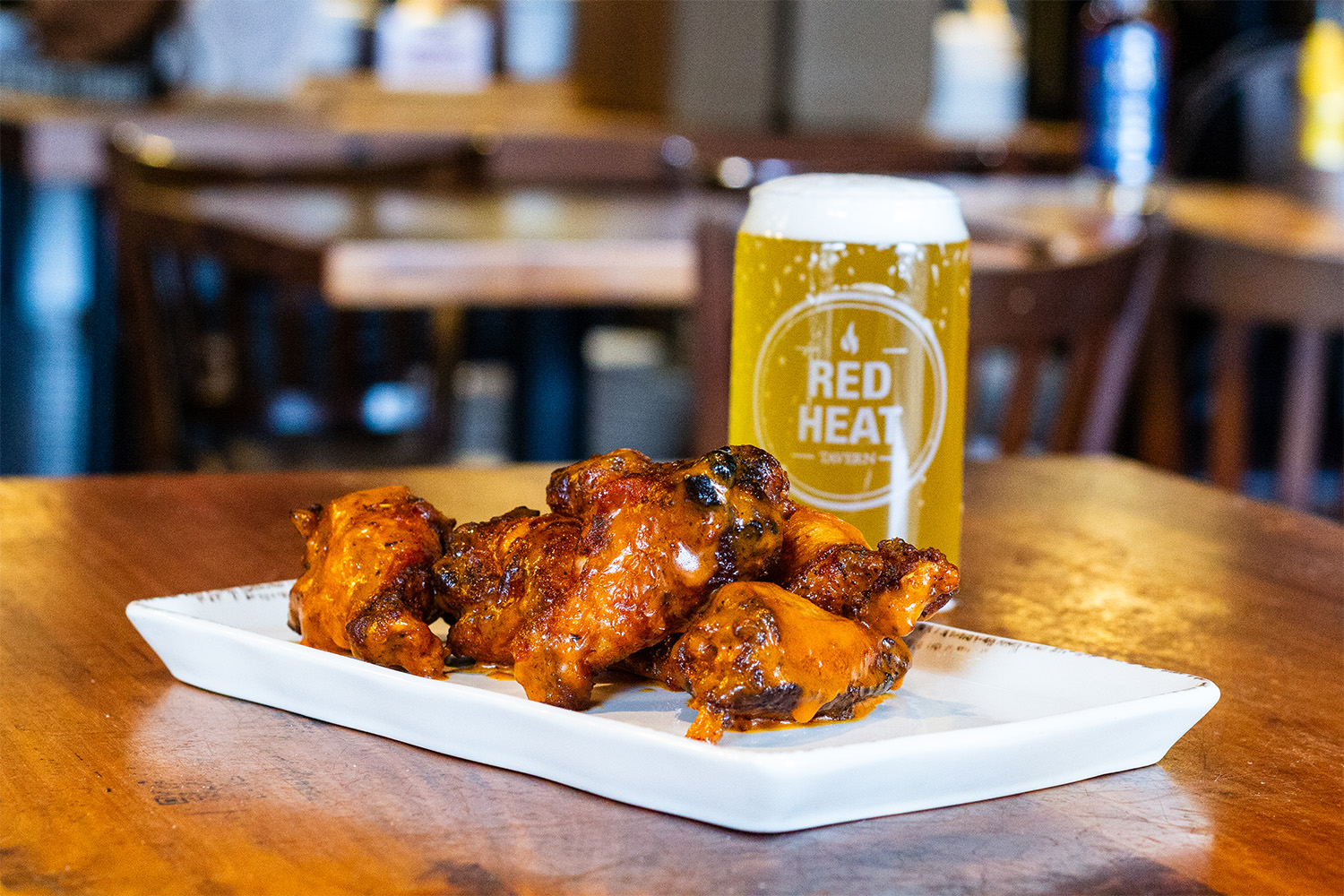 Bone-in wings with a beer sitting on a wooden table