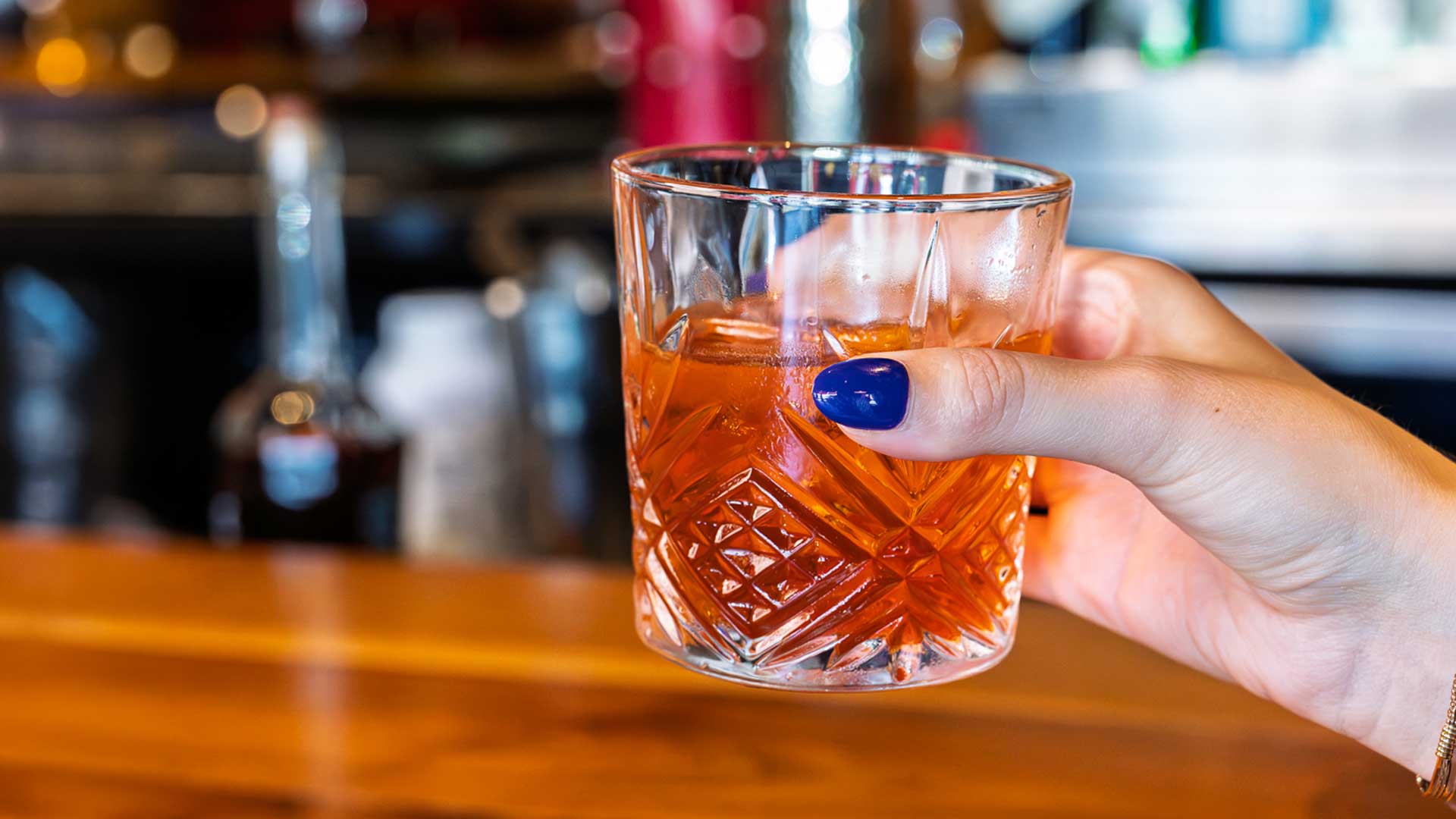 The Illusionist cocktail featuring bourbon, licor 43, maple, house bitters, and smoke